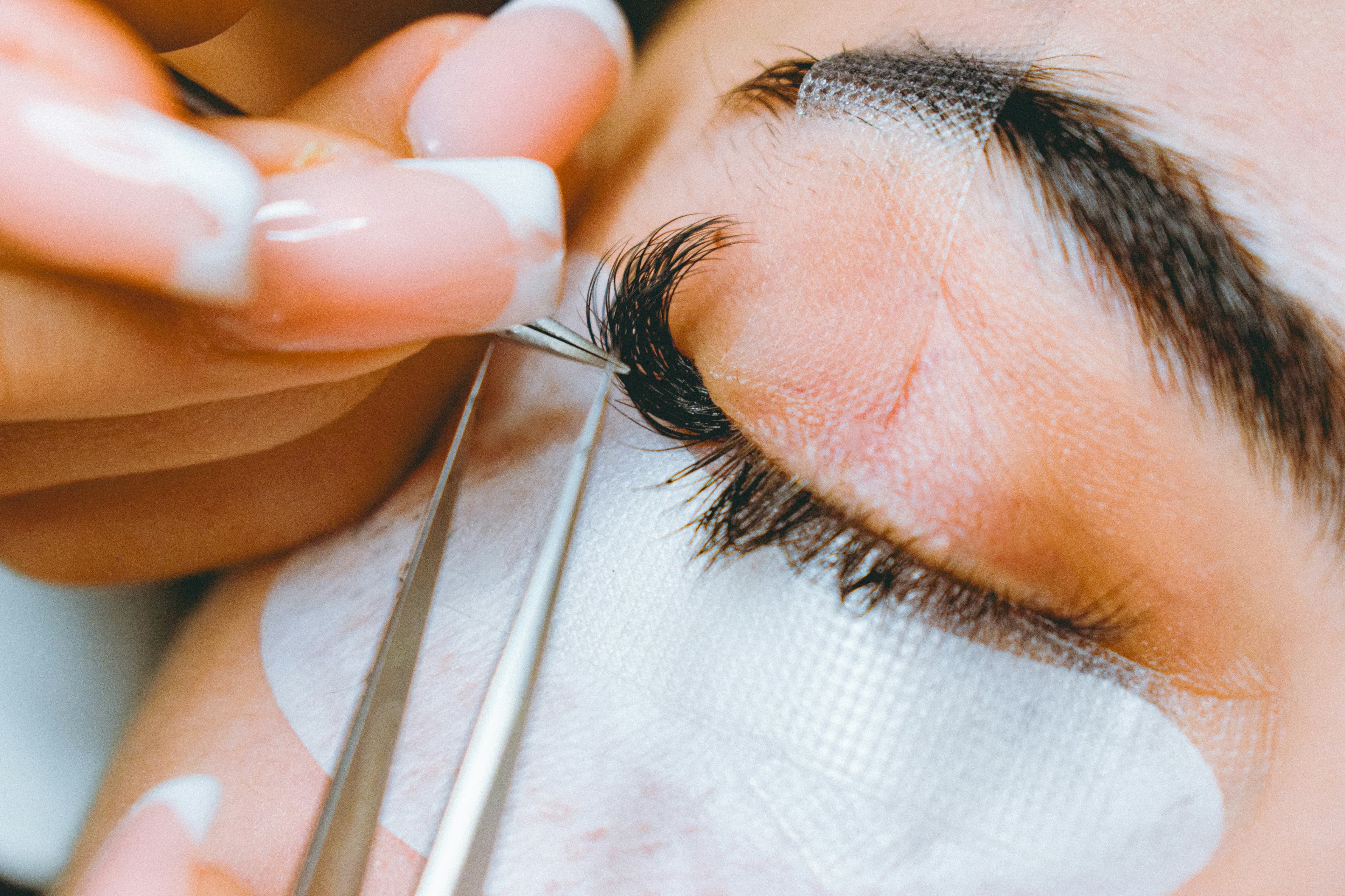 Close-up of lash extension application